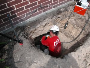 olshan crew member installing pilings under concrete slab in batn rouge
