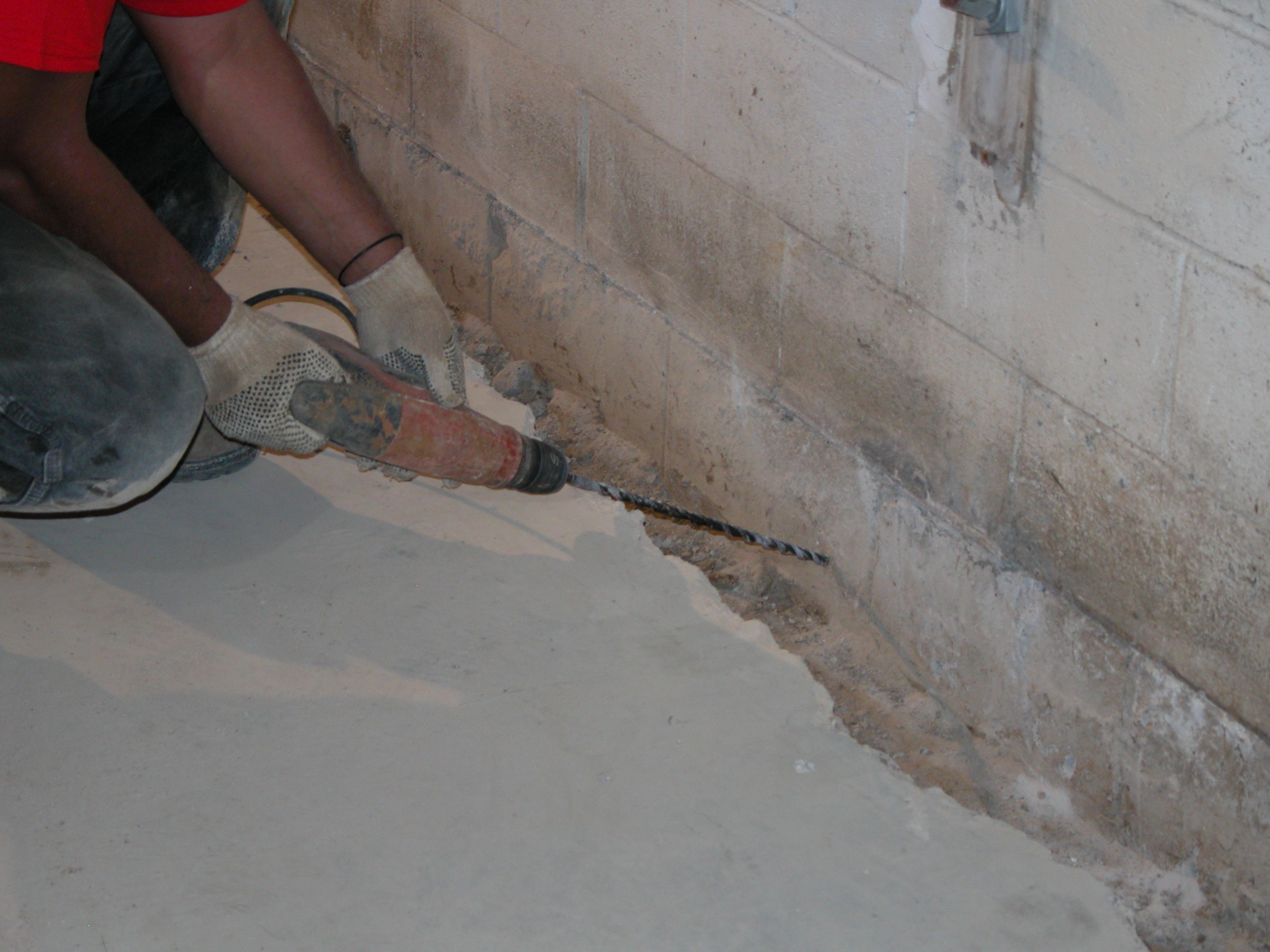 Close-up of specialized drilling in basement waterproofing project aiming for maximum water protection and structural integrity Close-up of specialized drilling in basement waterproofing project aiming for maximum water protection and structural integrity