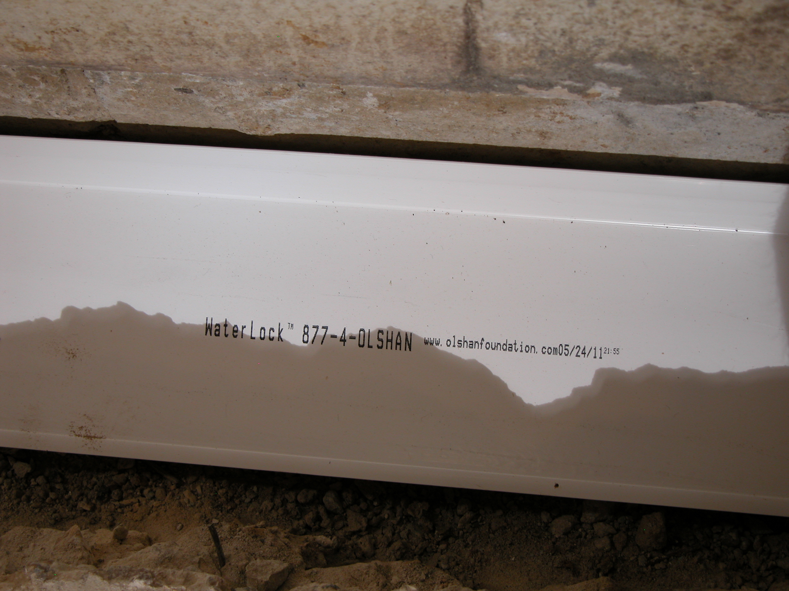 Close-up of Olshan Waterlock installation ensuring reliable basement waterproofing and moisture control for enhanced property value Close-up of Olshan Waterlock installation ensuring reliable basement waterproofing and moisture control for enhanced property value