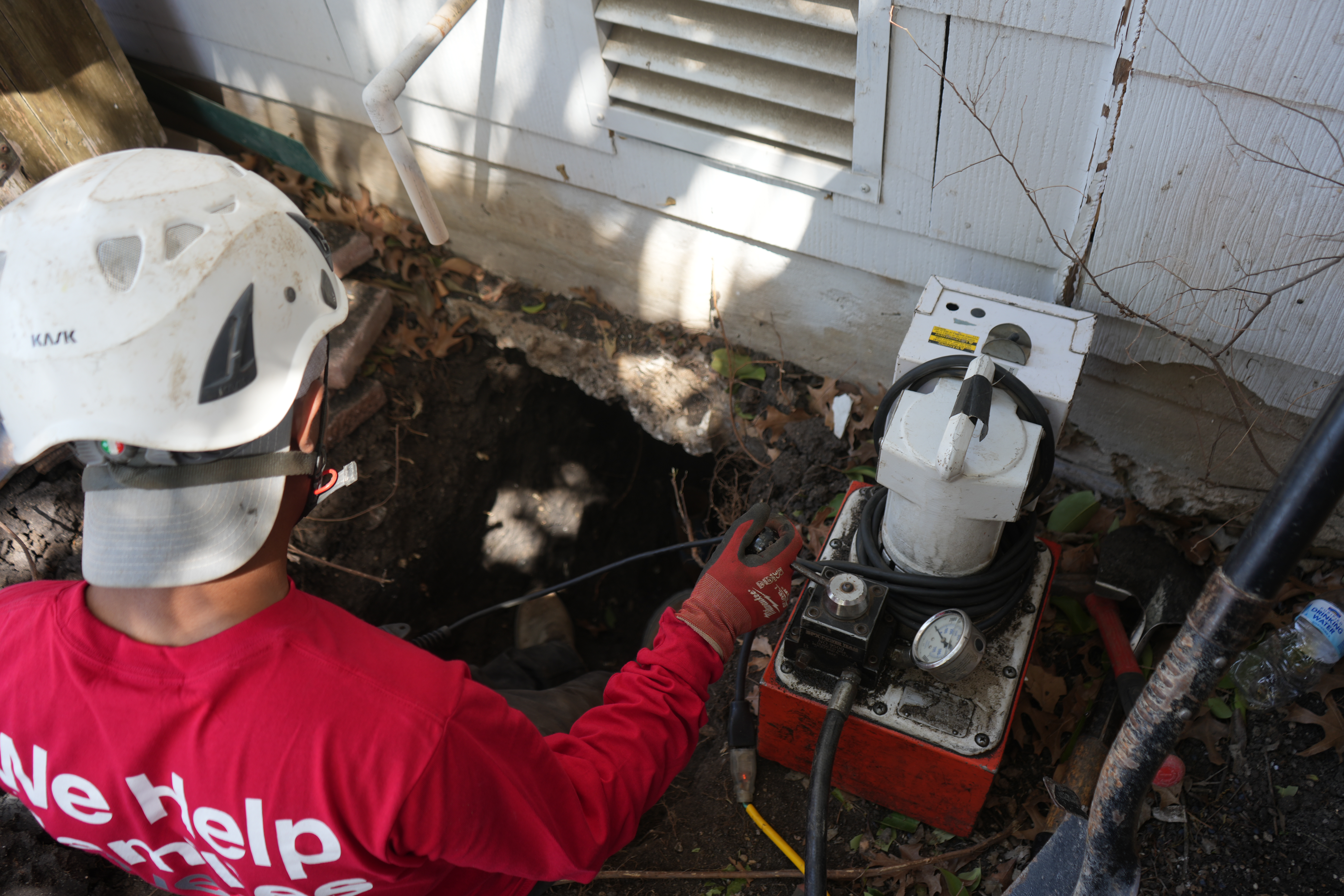 Foundation A Certified Structural Technician inserting the CableLock system into the ground.