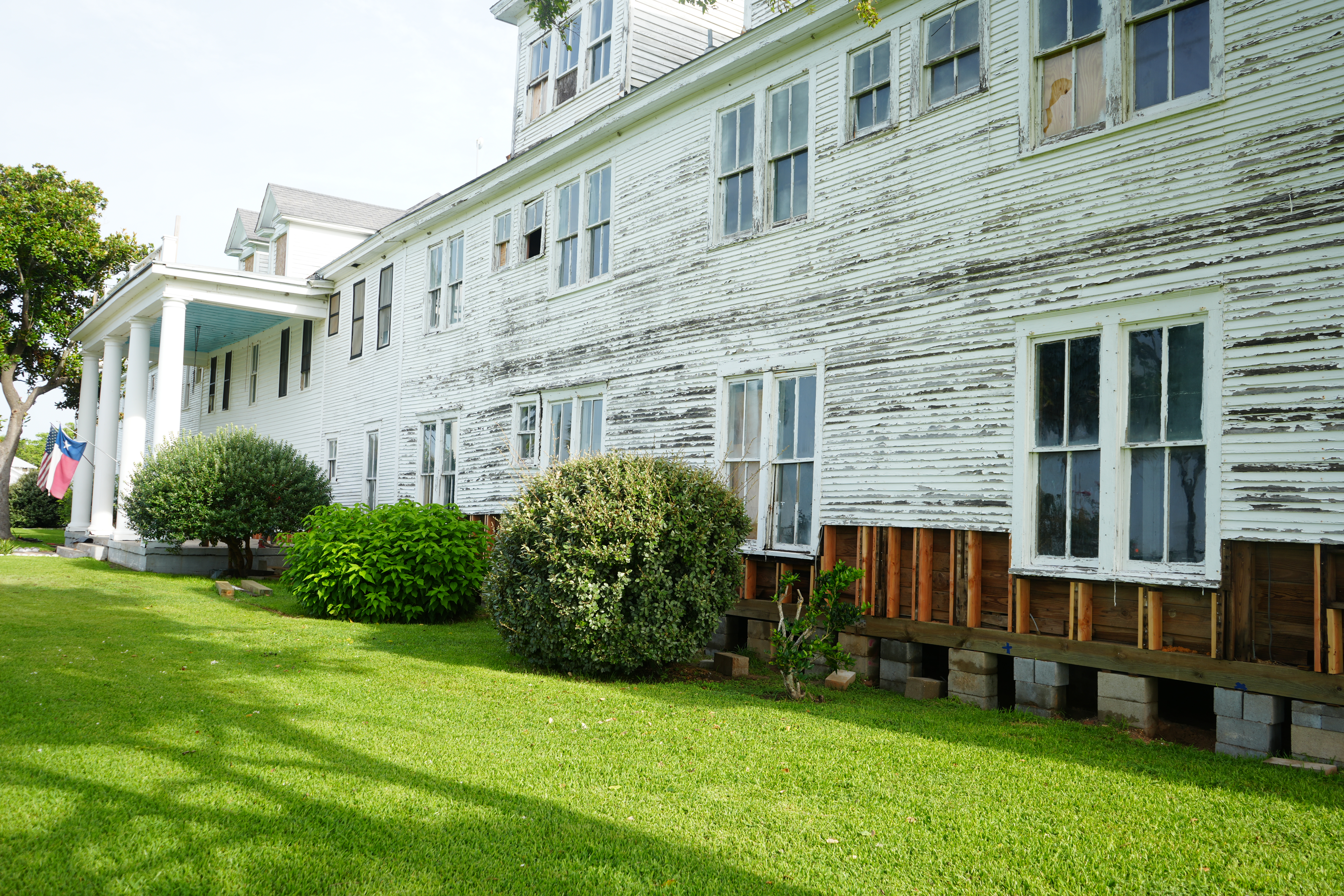 Historic home receiving expert structural enhancement, with exposed foundation for advanced repair techniques. Historic home receiving expert structural enhancement, with exposed foundation for advanced repair techniques.
