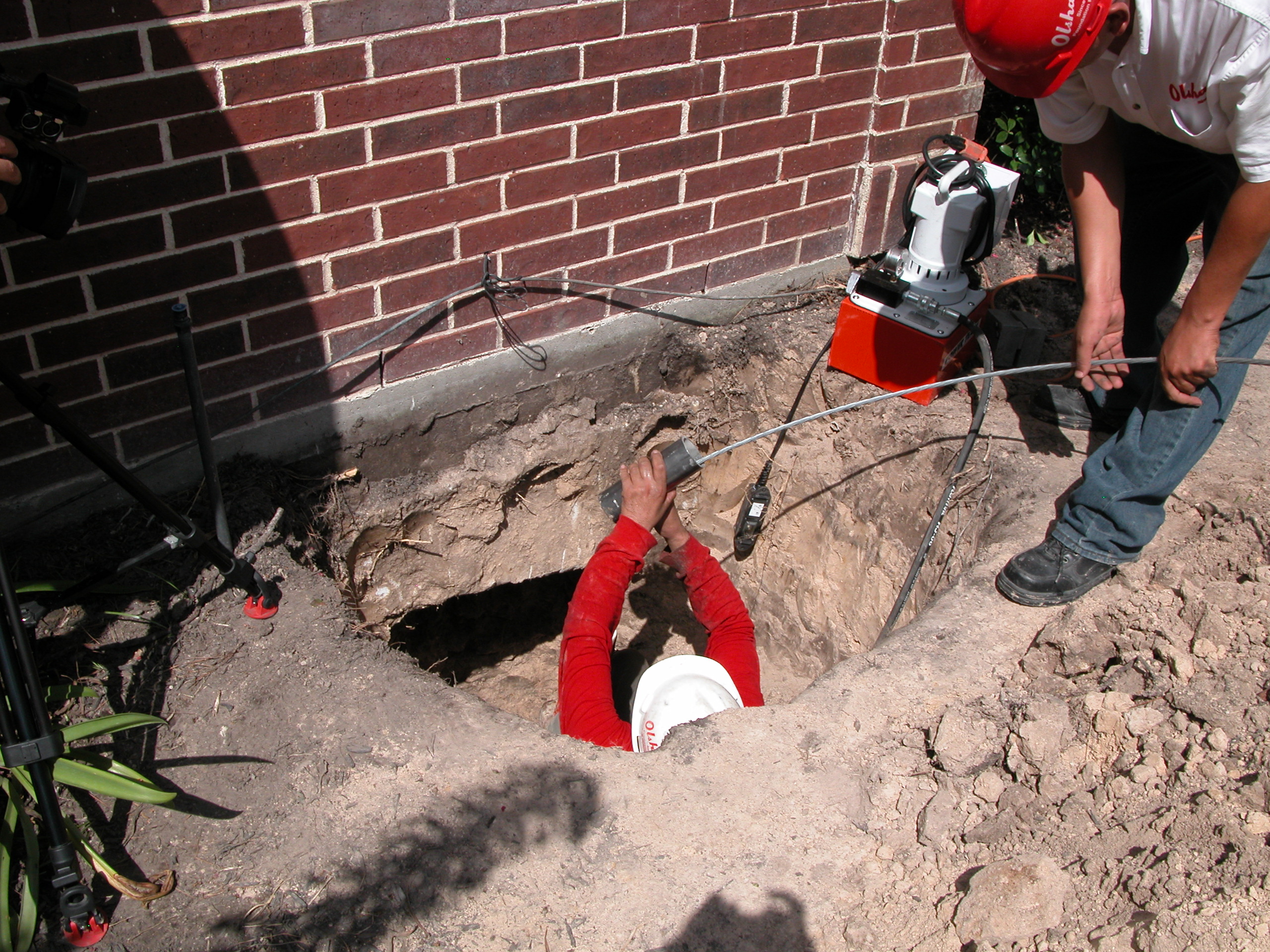 Team executing precise brick wall stabilization and foundation reinforcement using industry-grade equipment. Team executing precise brick wall stabilization and foundation reinforcement using industry-grade equipment.