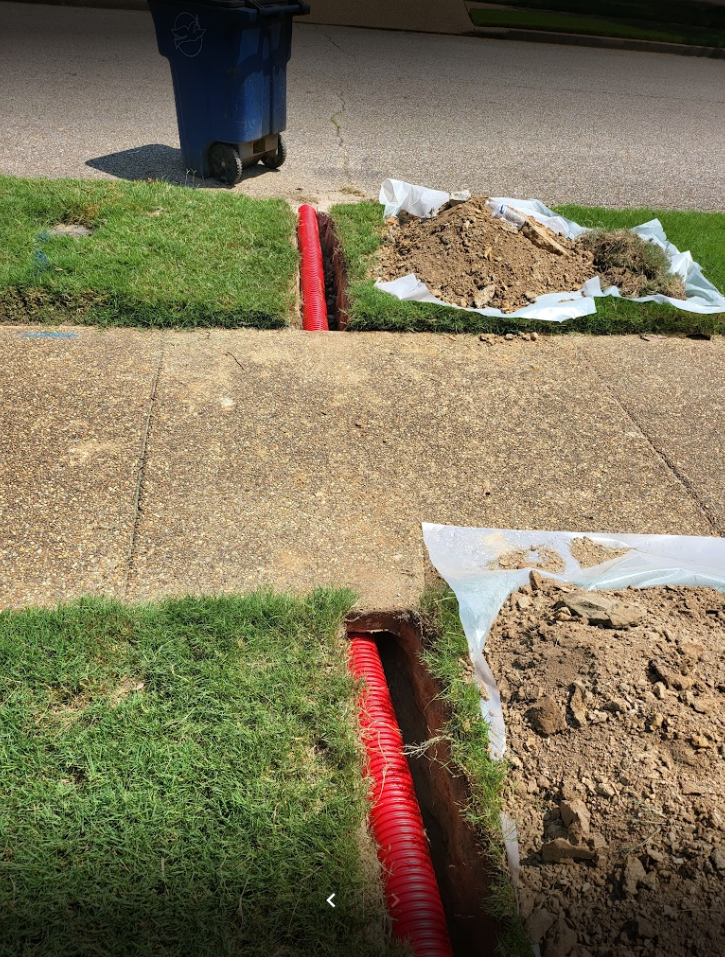 Efficient trench digging for residential French drain system installation to prevent lawn flooding and soil erosion Efficient trench digging for residential French drain system installation to prevent lawn flooding and soil erosion