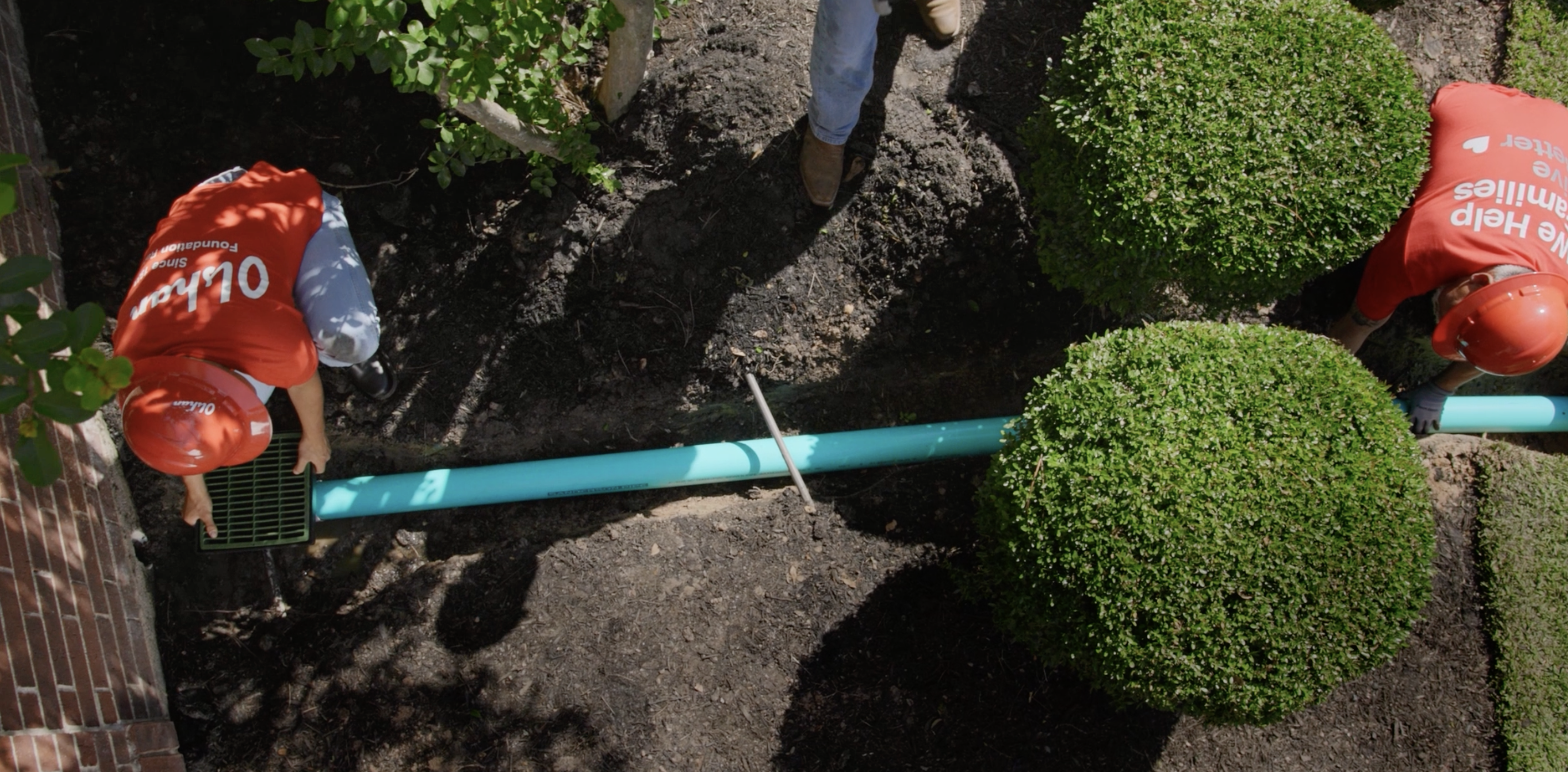 Olshan professionals positioning a French drain pipeline to optimize residential water drainage and protect garden aesthetics Olshan professionals positioning a French drain pipeline to optimize residential water drainage and protect garden aesthetics
