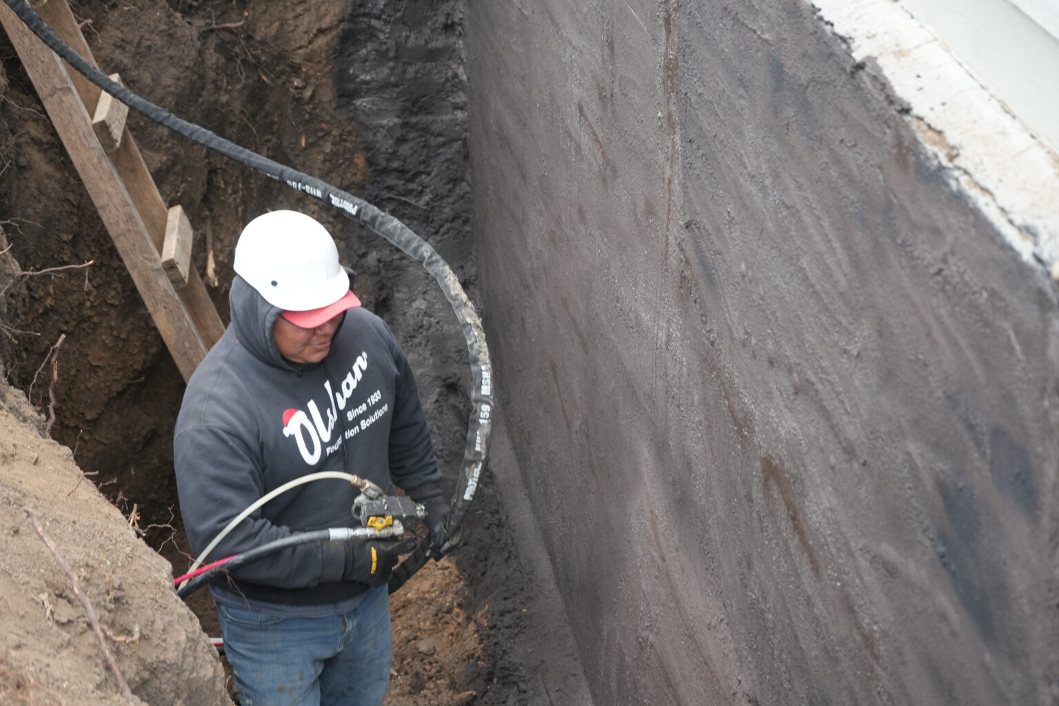 Excavated basement wall coated with seamless WetSuit membrane